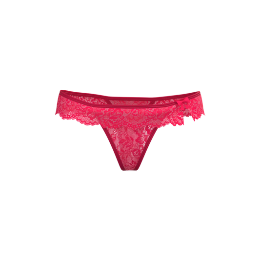 A vibrant fuchsia silk lace thong with delicate floral patterns and a small side bow magic silk flutter thong