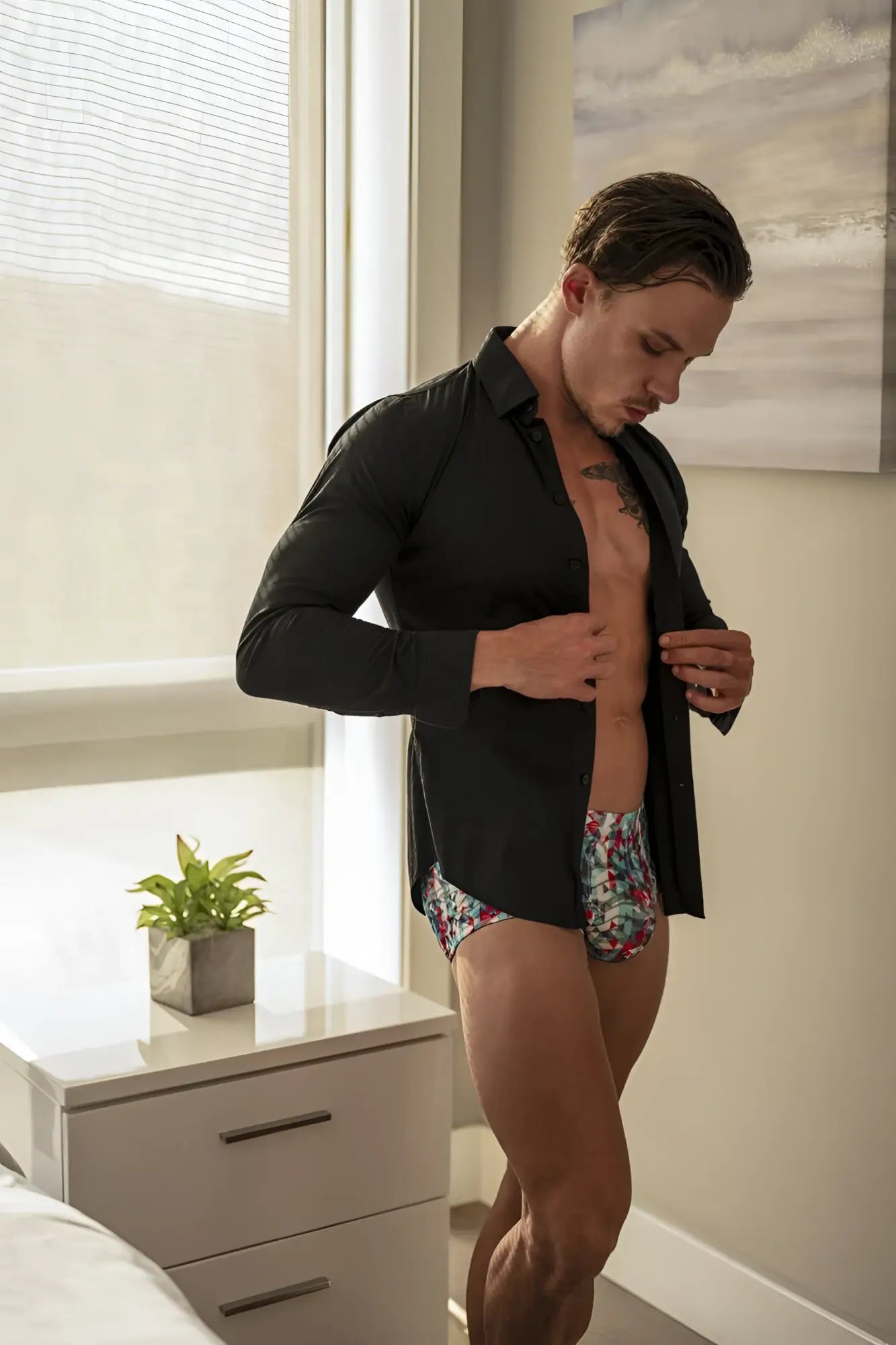 Man wearing Male Power 131-293 Your Lace Or Mine red white blue pouch shorts with floral patterned underwear and black shirt