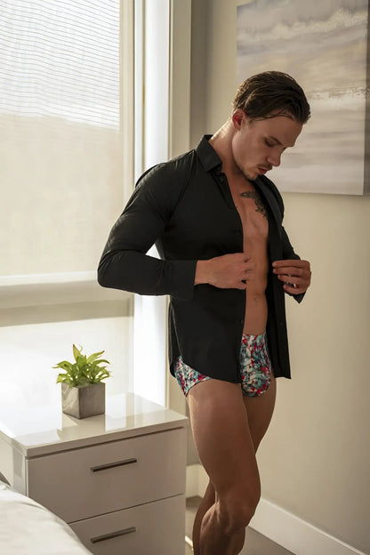 Man wearing Male Power 131-293 Your Lace Or Mine red white blue pouch shorts with floral patterned underwear and black shirt
