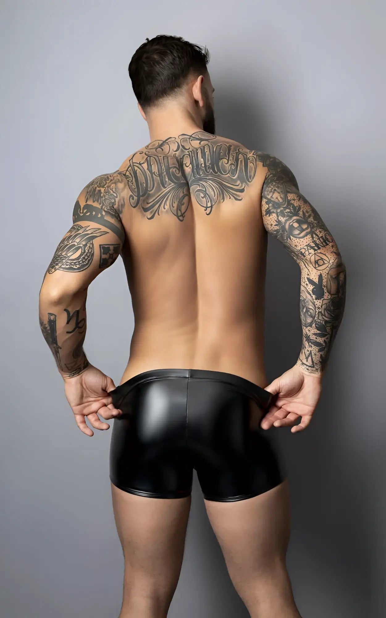Male Power 153-301 liquid onyx 2.0 black glossy latex pouch shorts shown from the back side