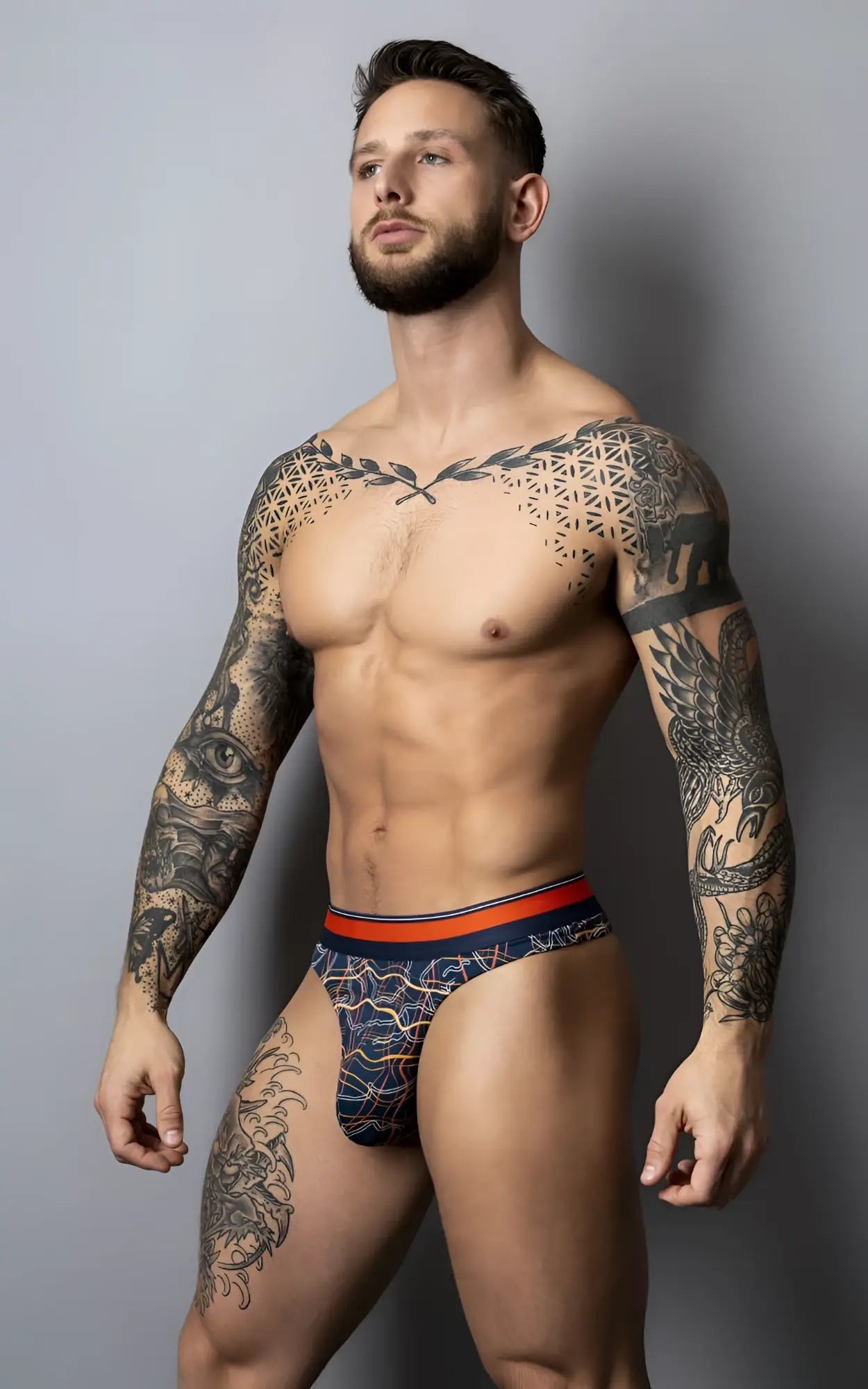 Navy blue patterned briefs with an orange waistband from male power 412-299 soo cumfy thongs collection