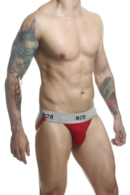 Red athletic briefs with a gray waistband featuring the mob logo from malebasics mb107 classic fetish jockstrap
