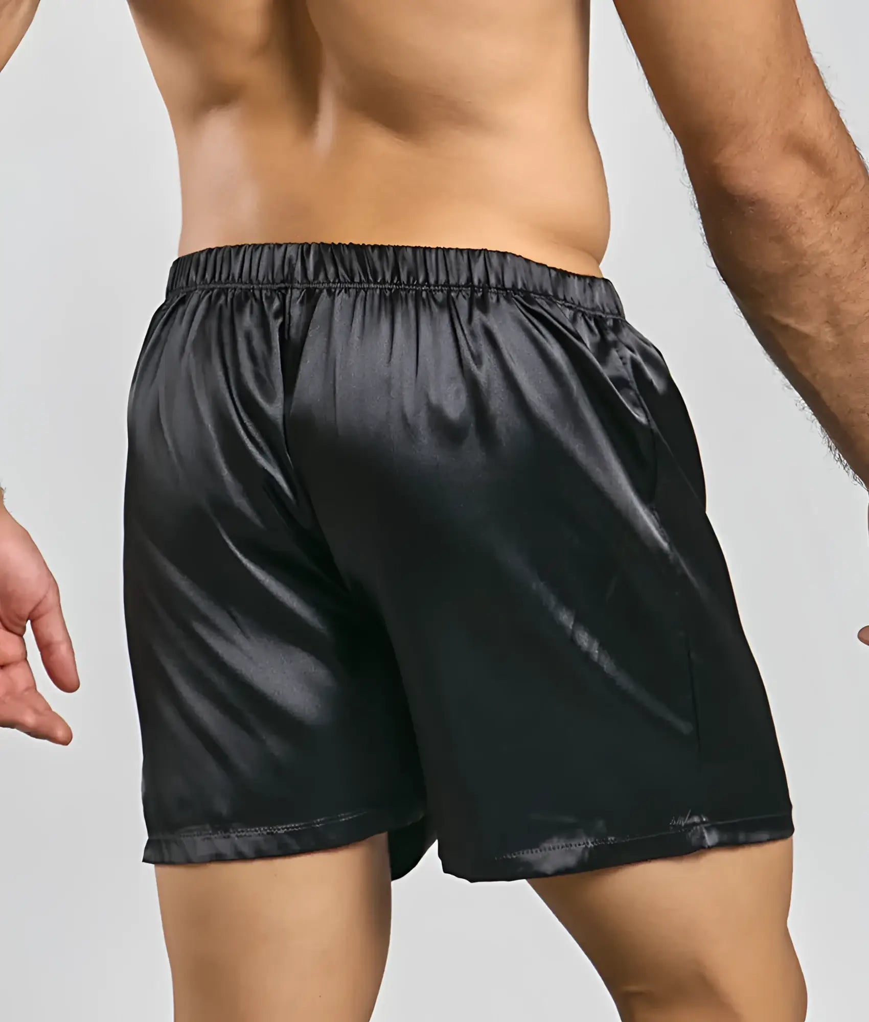 Black satin shorts from malebasics featuring a smooth glossy finish and elastic waistband for comfort