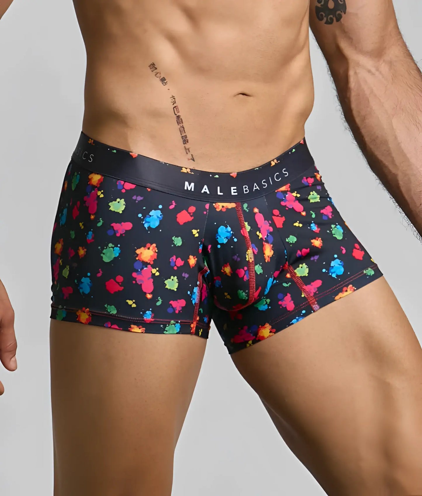 Black mens boxer briefs with multicolored paint splatter pattern and malebasics branded waistband in trunk hipster style