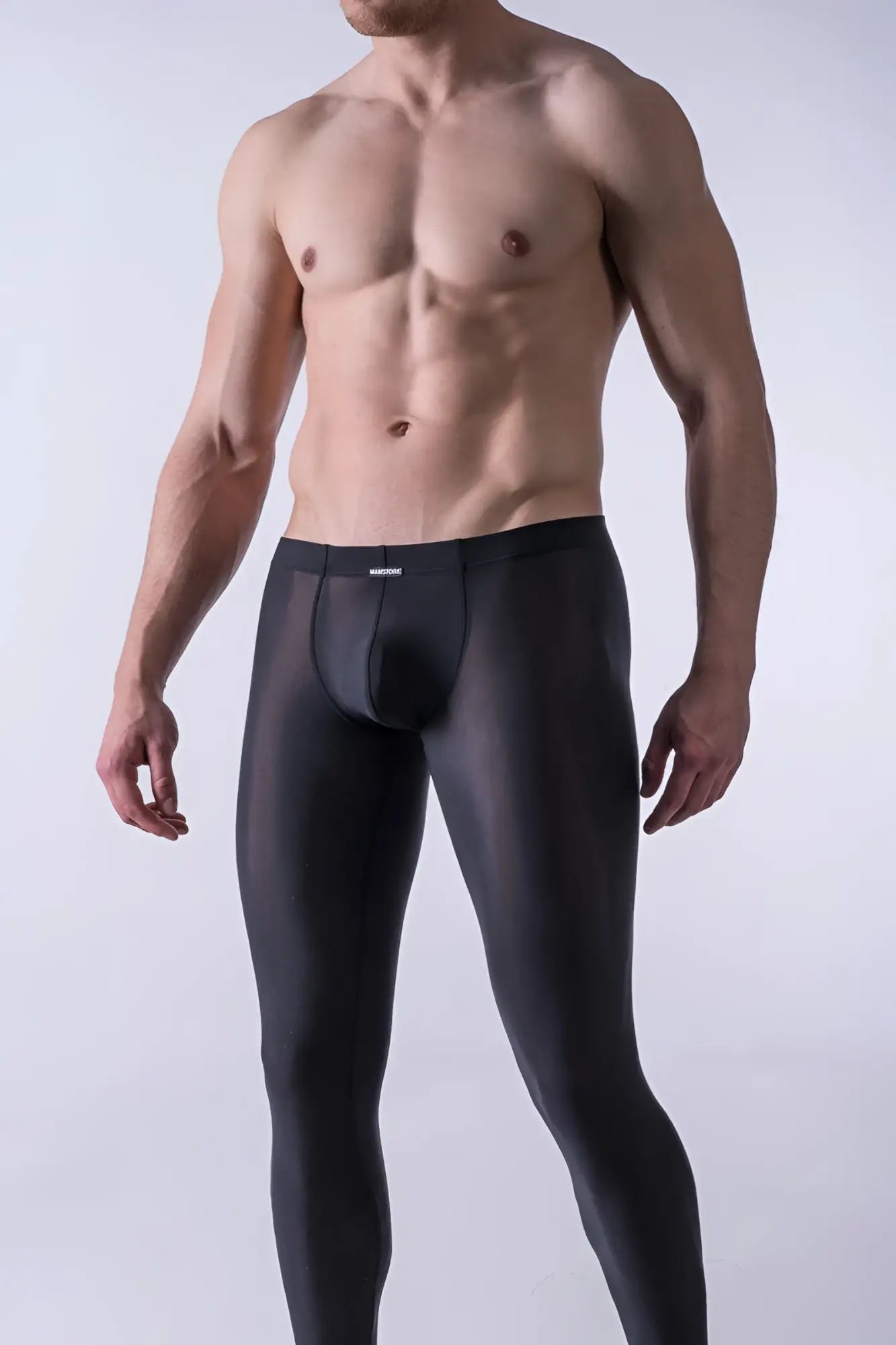 Black sheer men’s underwear with contoured design and manstore logo on waistband in size medium