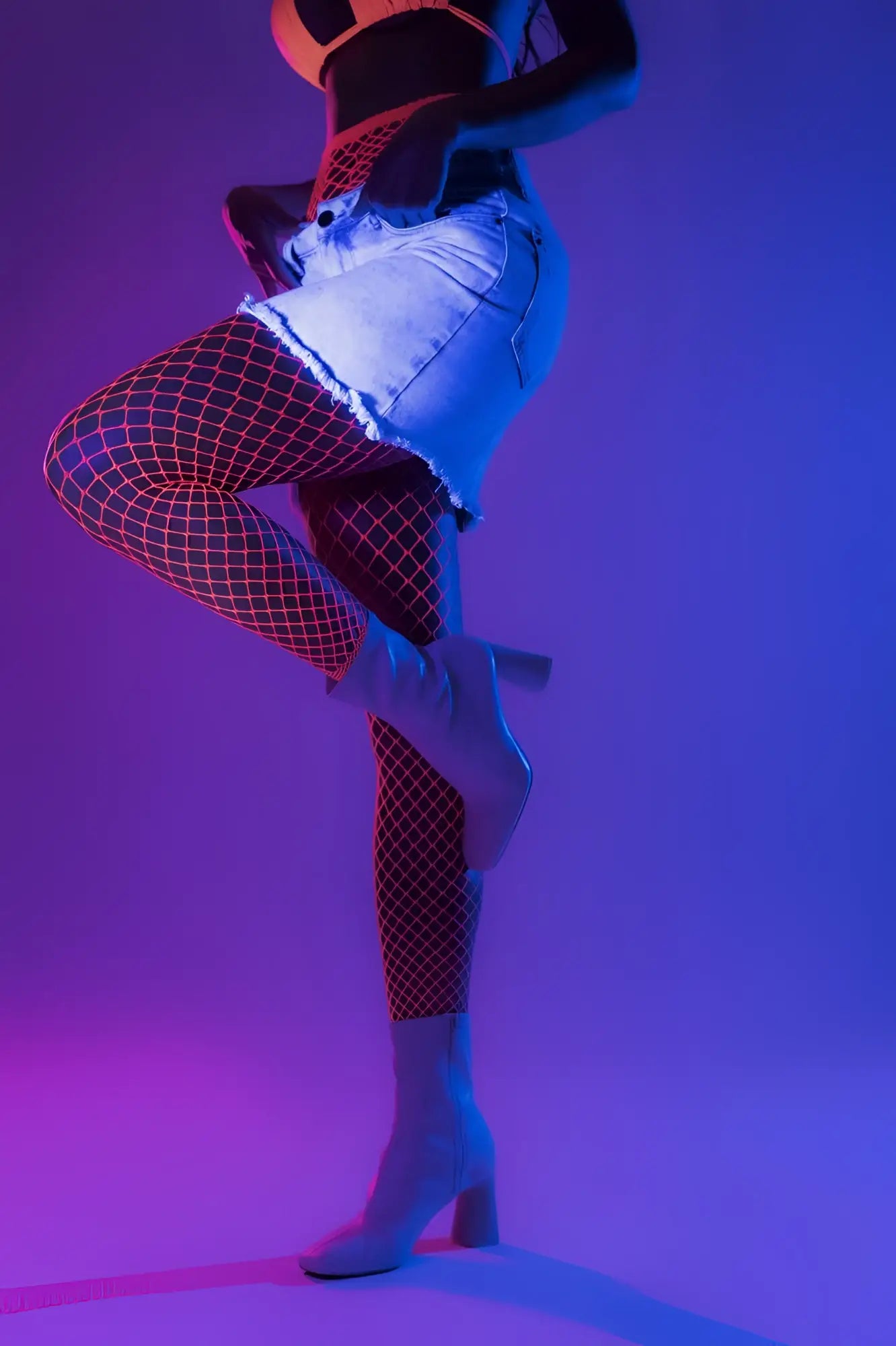 White heeled ankle boots with block heel and sleek modern design paired with neon pink mapale 1120 stocking fence net
