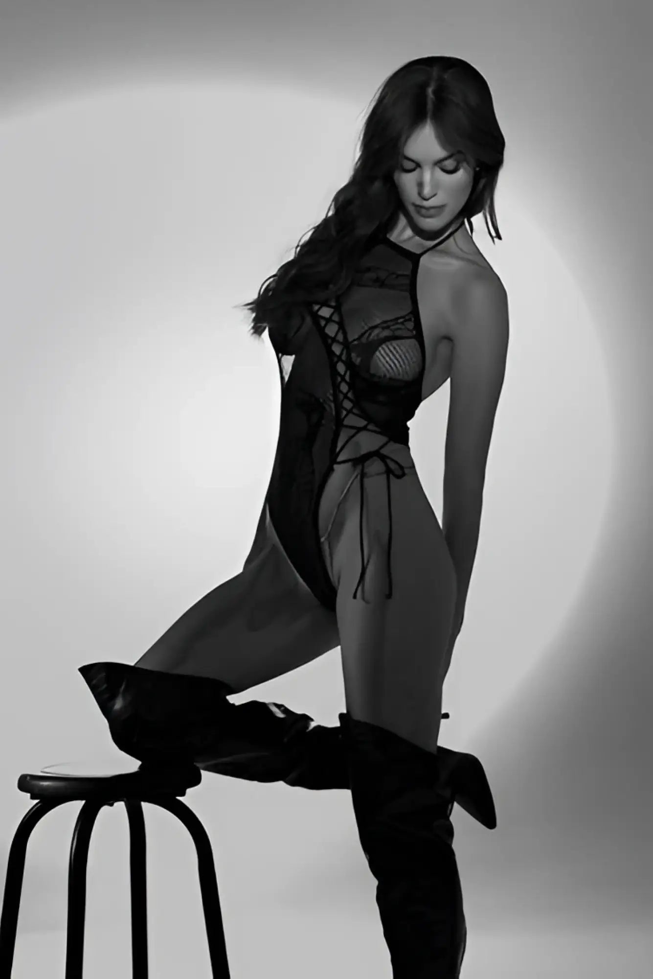 Black lace bodysuit with mesh panels and crisscross lacing detail by Mapale in black color front view