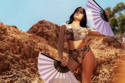 A woman wearing a mapale 2799 two piece set in black and white with eye motif and bohemian mystique pattern