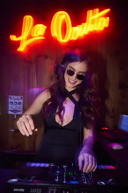 Black serato dj controller with illuminated buttons and knobs under neon lighting in mapale 40007 dress color black