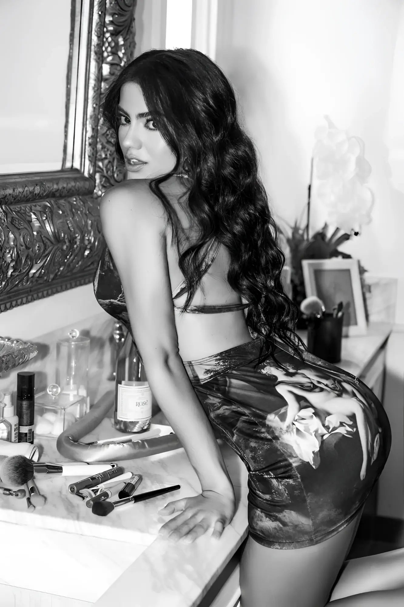 Black and white photo of a woman wearing a high-waisted glossy mini skirt with classical painting design mapale 40012 amalfi dream