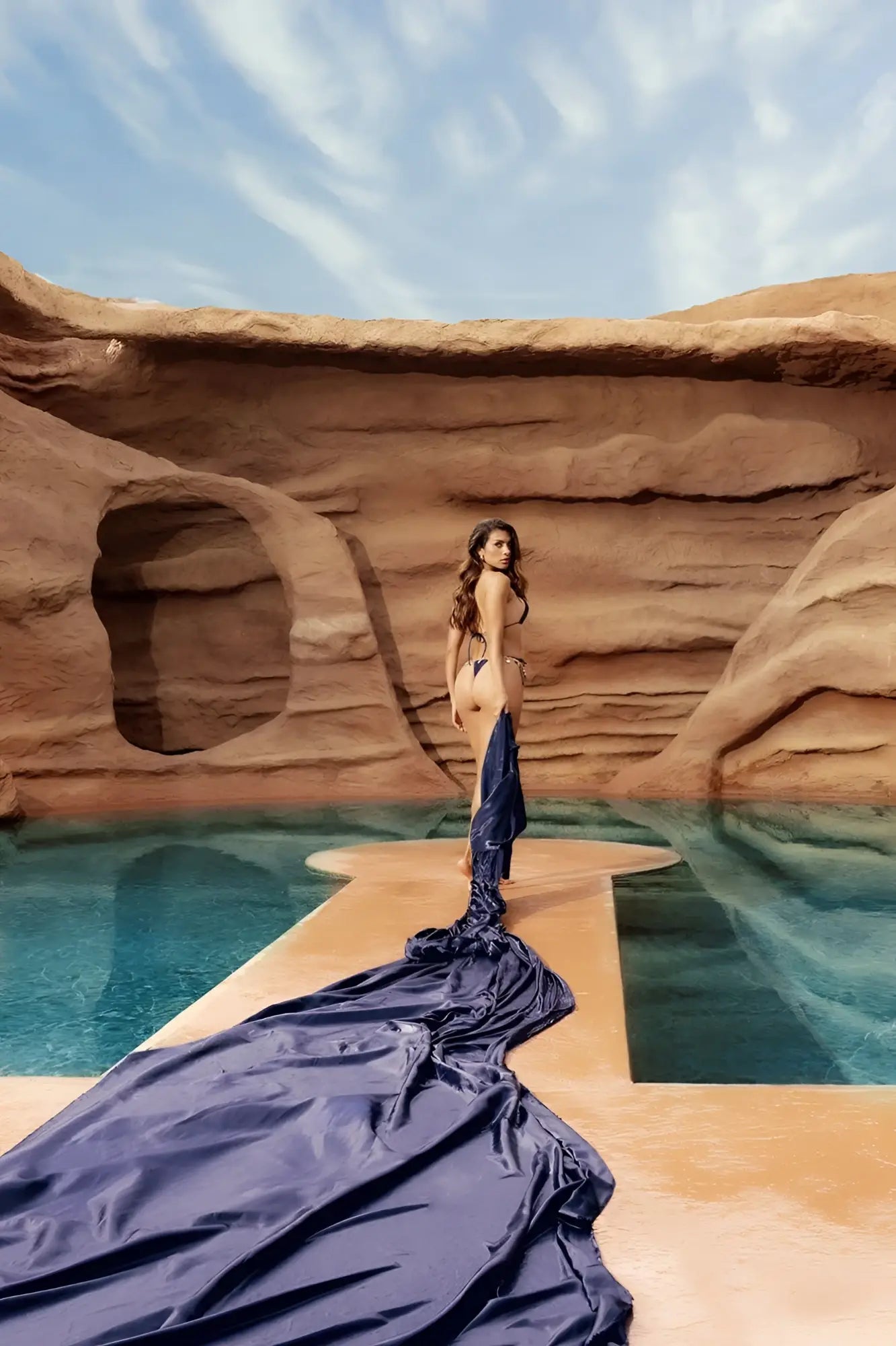 A deep ocean color mapale 67158 two piece swimsuit with flowing navy blue satin fabric draped elegantly poolside
