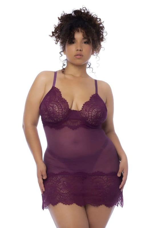 A plus-size woman wears a wine color sheer purple lace Mapale 7554X babydoll lingerie with floral patterns and straps