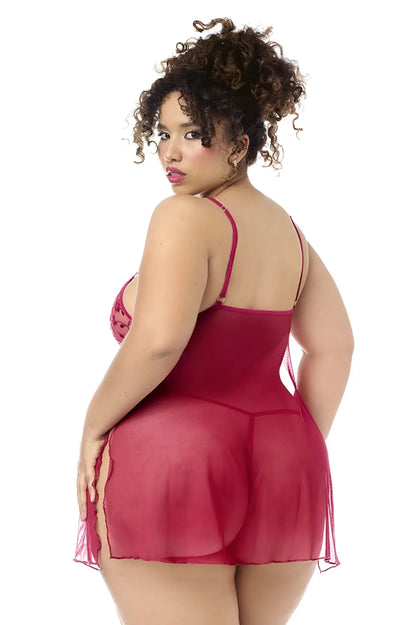 A plus-size woman wearing a sheer deep red mapale 7620x babydoll lingerie dress with lace bodice and matching panty