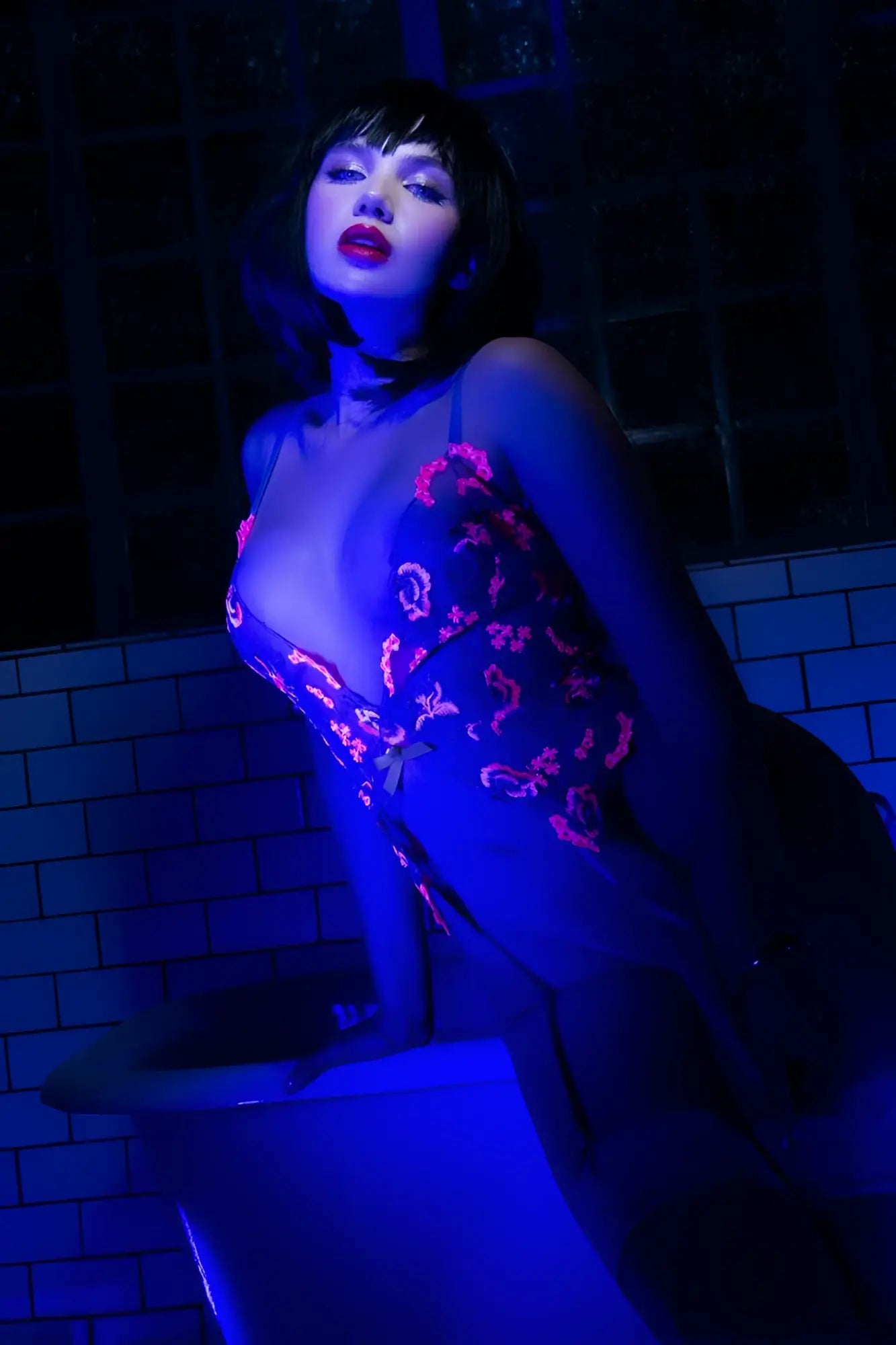 Mapale 80011 bodysuit in hyacinth reverie featuring a dark sheer fabric with vibrant pink embroidered floral patterns