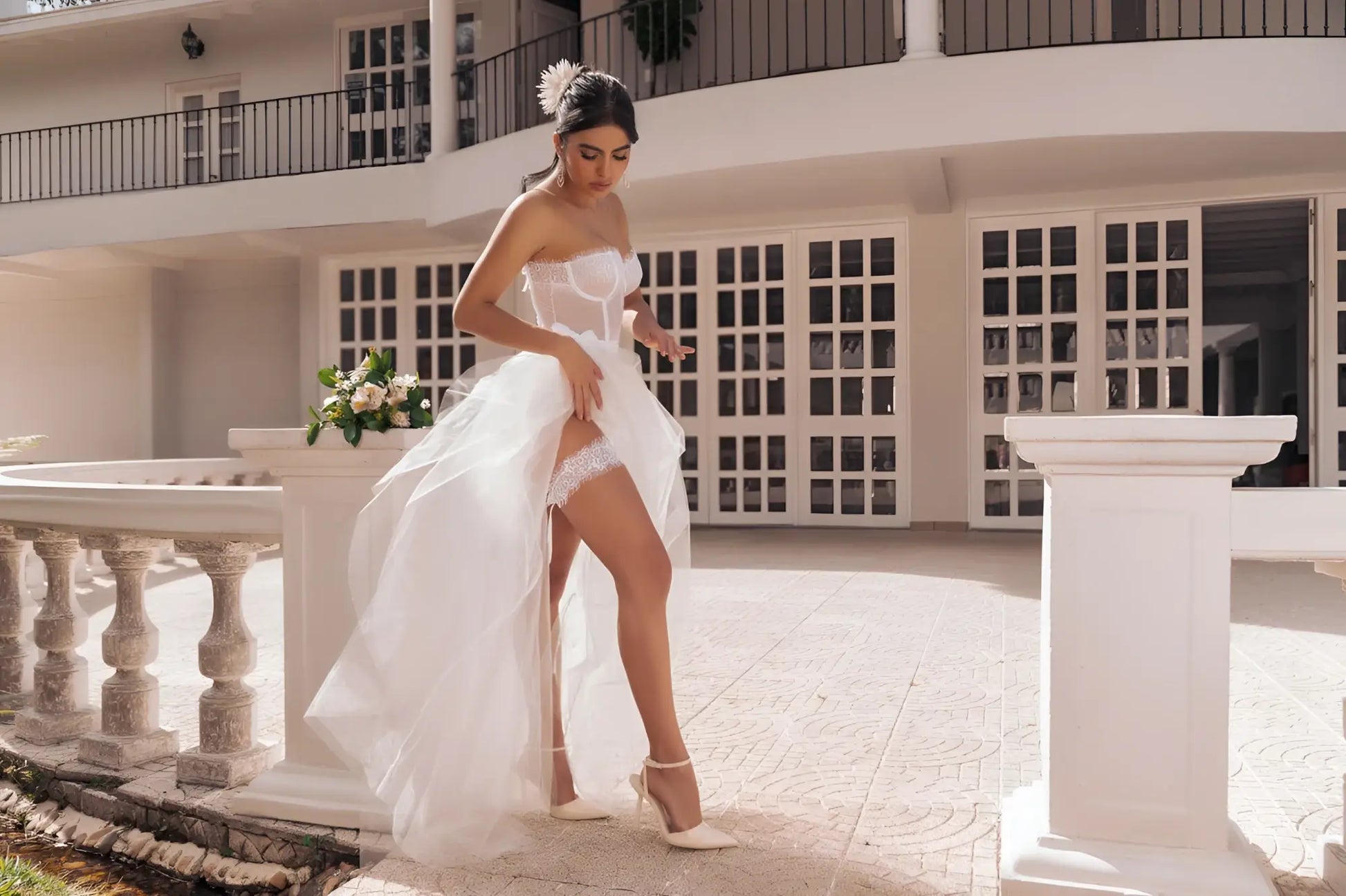 A flowing white mapale 8933 four piece bridal gown with high slit and delicate lace trim