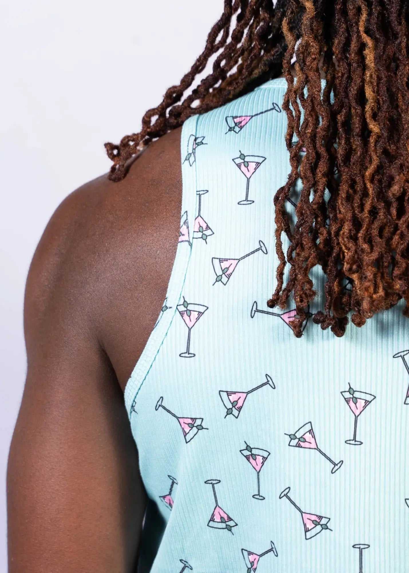 Light blue ribbed tank top with playful pink martini glass pattern outlined in black martini print tank
