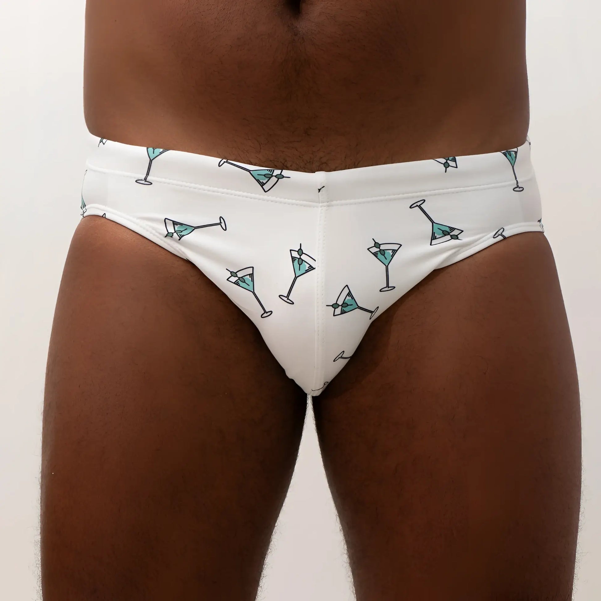 White swim brief with teal martini glass pattern and black outlines designed for stylish beachwear