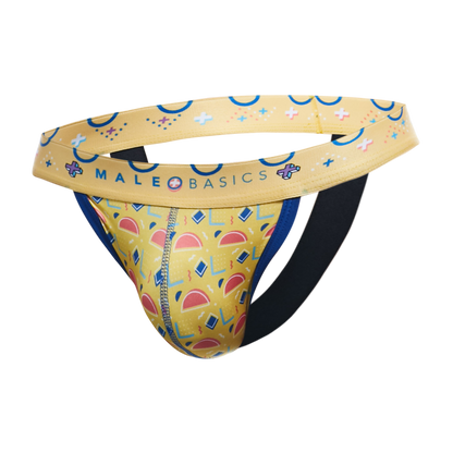 A men's jockstrap by MaleBasics featuring a yellow and blue geometric pattern, a wide yellow waistband with blue accents, and a black elastic leg strap, shown against a plain white background.