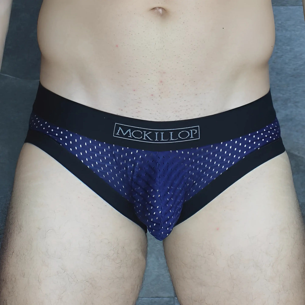 Dark blue mesh briefs with black trim and white mckillop logo on waistband from mckillop mckobpl brief collection