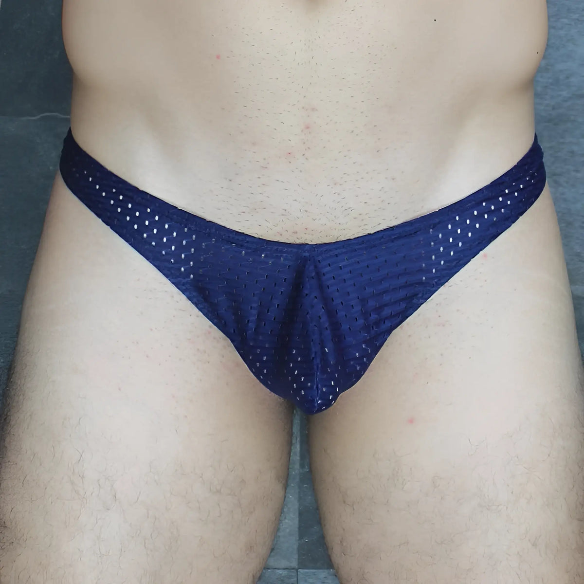 Navy blue mesh Mckillop MCKVTPL thong briefs with textured breathable fabric and a snug fit showing the back side
