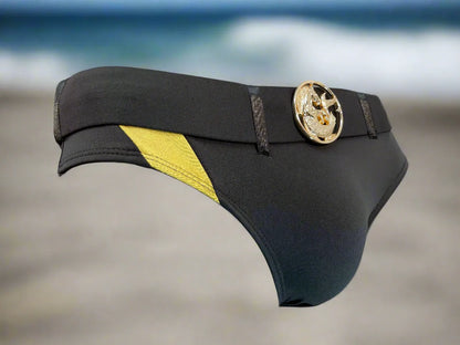 Black and yellow men's swim briefs with a gold medallion detail made by Maris Equi featuring a sleek design.