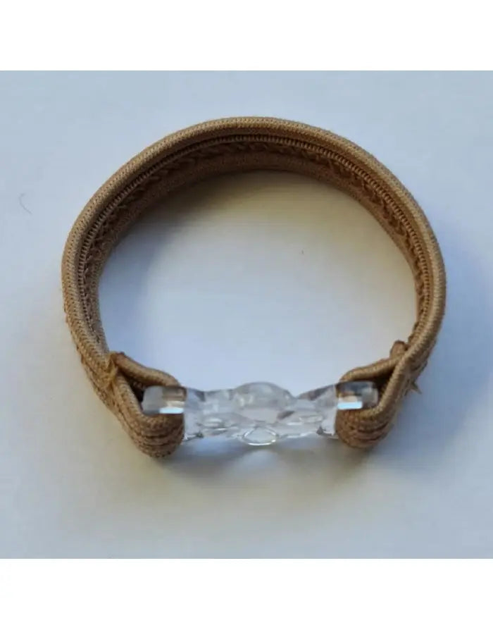Transparent snap cock strap with a beige elastic band featuring a clear adjustable closure by Arroyman.