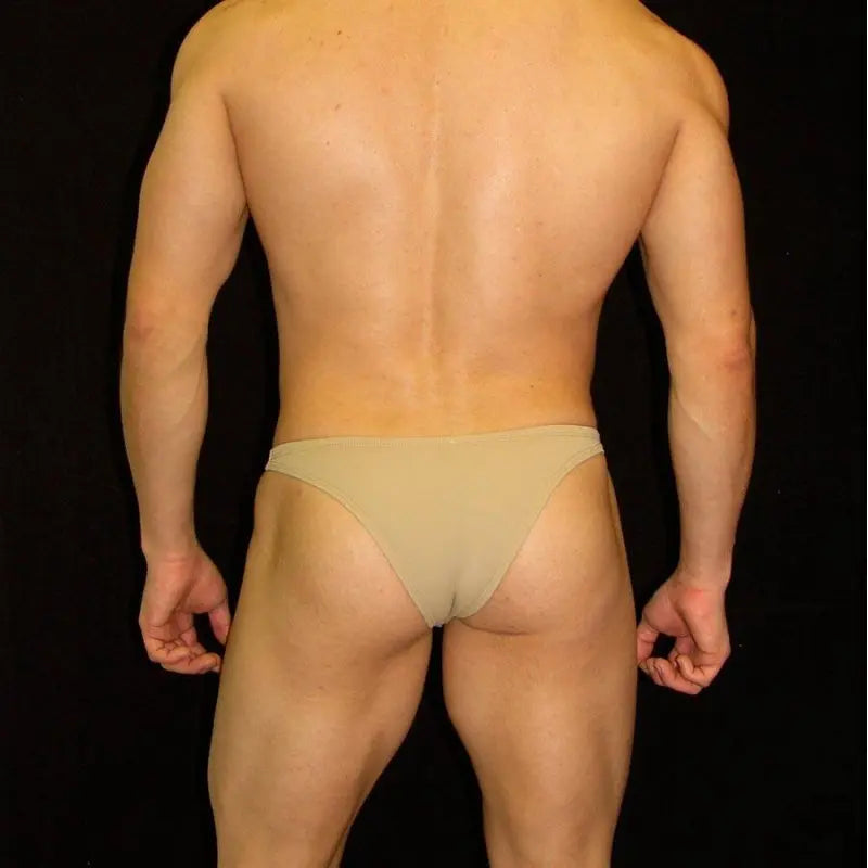 Nude micro bikini underwear for men by Arroyman featuring a minimal coverage design and soft fabric shown on a model from the back.