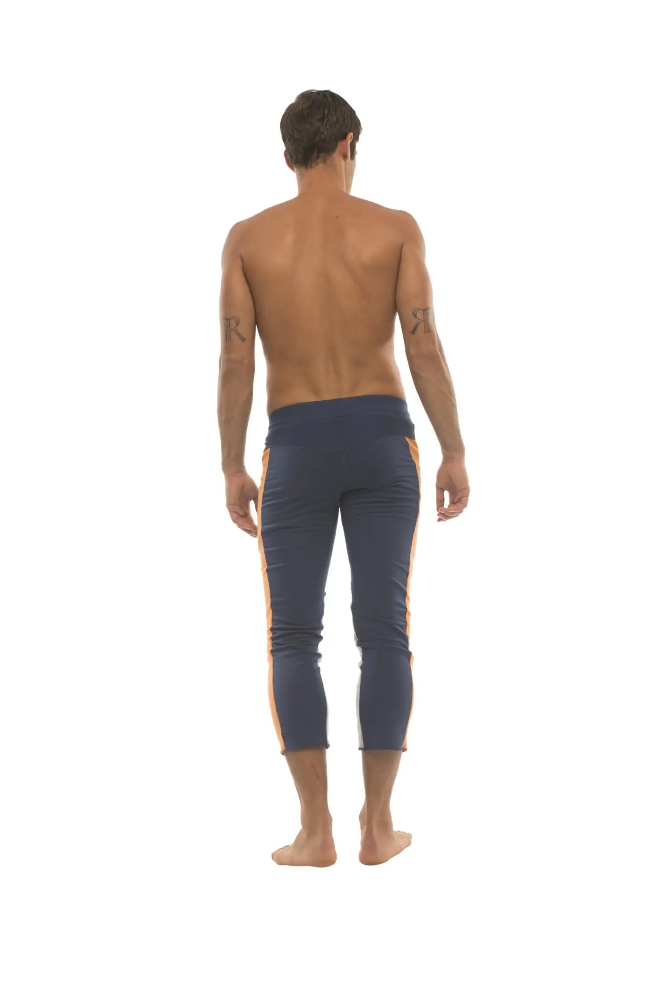 Mens navy blue capri yoga pants with orange side stripes and 4 zipper pockets for versatile activewear use