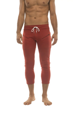 Mens 4/5 zipper pocket capri yoga pants in solid cinnabar red with white drawstring waistband and side pockets