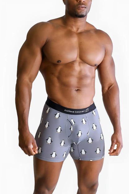 Menâ€™s gray boxer briefs with white penguin pattern and black elastic waistband featuring curious beaver brand name