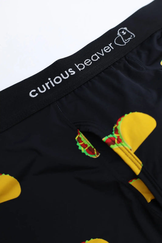 Menâ€™s boxer briefs with a playful taco print featuring yellow shells green lettuce and red meat fillings