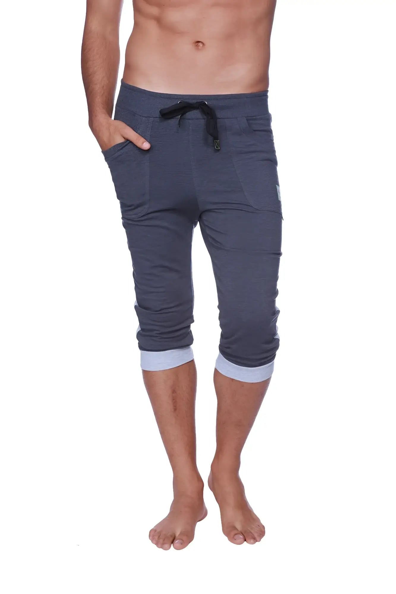 Mens cuffed yoga pants in charcoal heather grey with dark gray fabric, black drawstring waistband, and light blue cuffs
