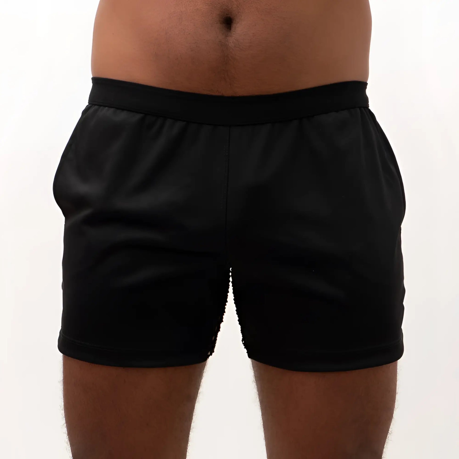 Black mesh back short athletic shorts with smooth stretchy fabric and elastic waistband shown from the back side