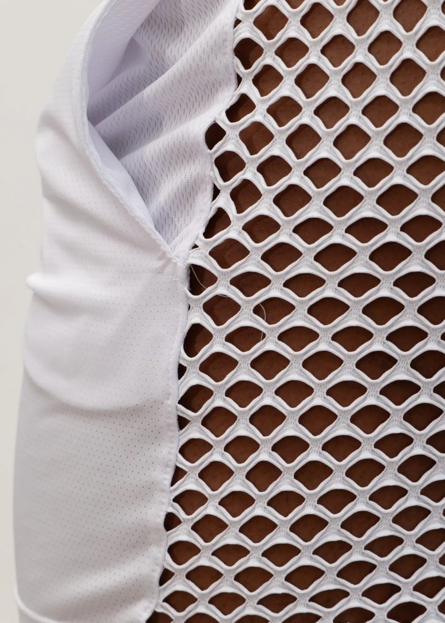 White mesh back short athletic vest with breathable diamond pattern and solid fabric arm panel for ventilation