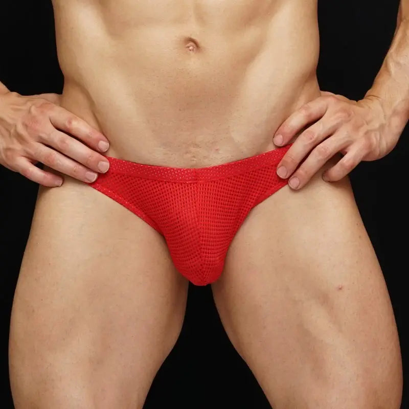 Red mesh bikini underwear by Arroyman featuring a breathable fabric and a snug fit shown on a model.