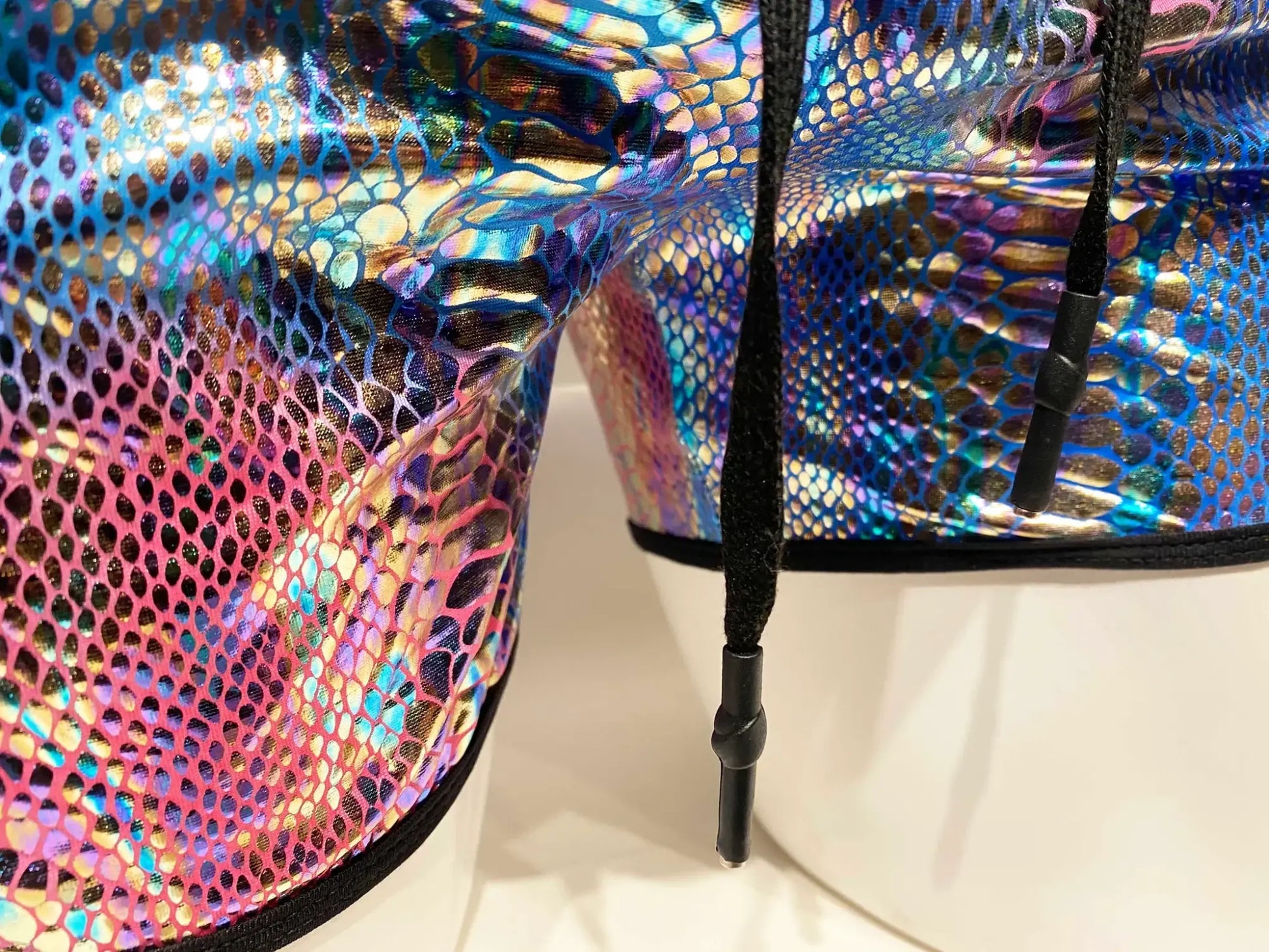 Metallic snake pocket shorts with iridescent snake-scale pattern and black drawstrings for a stylish look