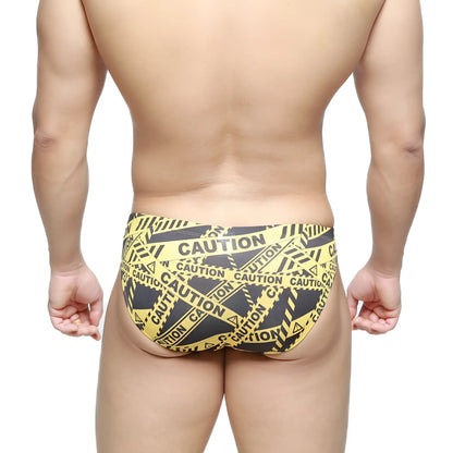 MetroMaleWear caution bikini swim trunks in yellow and black caution tape pattern for bold beachwear style