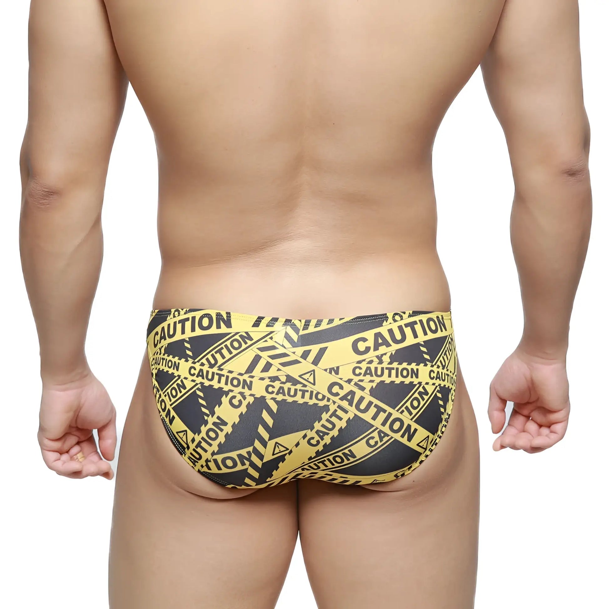 MetroMaleWear caution lowrise bikini swim trunks in black with yellow and black caution tape pattern front view