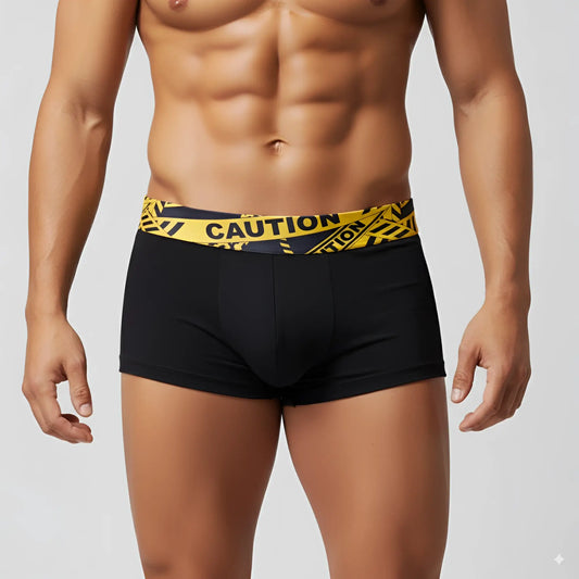 Black boxer briefs by MetroMaleWear with a bold yellow caution tape patterned waistband for everyday comfort