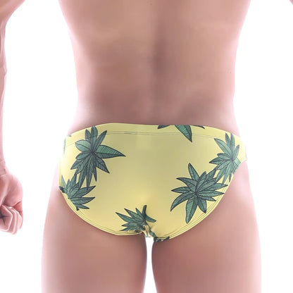 Yellow swim bikini by MetroMaleWear featuring a repeating green cannabis leaf pattern for classic beachwear