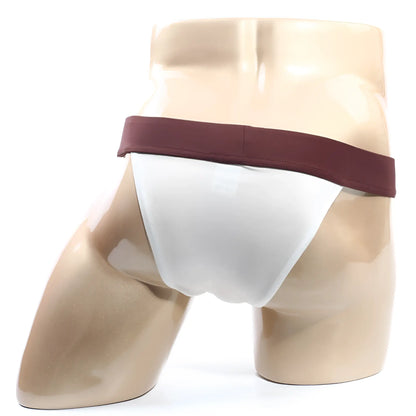 White MetroMaleWear Cosmos bikini briefs with maroon waistband displayed on a mannequin in cream fabric