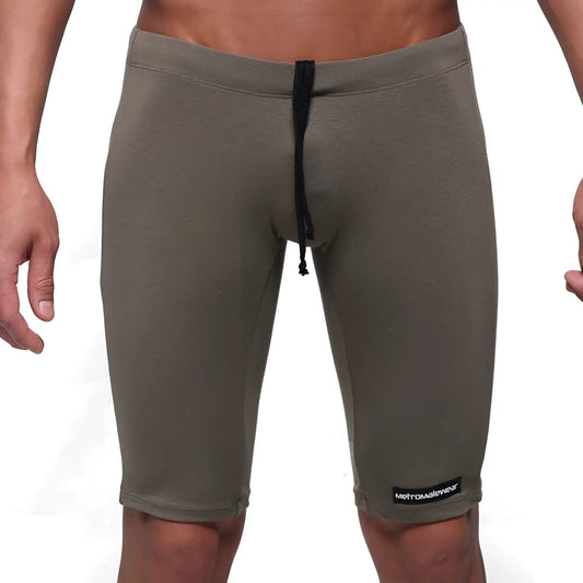 Olive green cotton athletic shorts with black drawstring and metromalewear logo patch on lower right leg