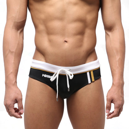 Black MetroMaleWear Edge swim brief with white waistband gold trim and white drawstring for stylish swimwear use