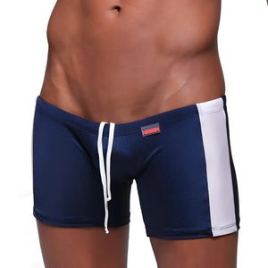 Navy blue MetroMaleWear Extreme Square swim trunks with white side stripes and matching drawstring waistband