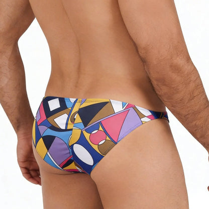 MetroMalewear fantasy bikini picasso 6116-87 swim trunks with vibrant geometric pattern in bold blues yellows pinks and purples