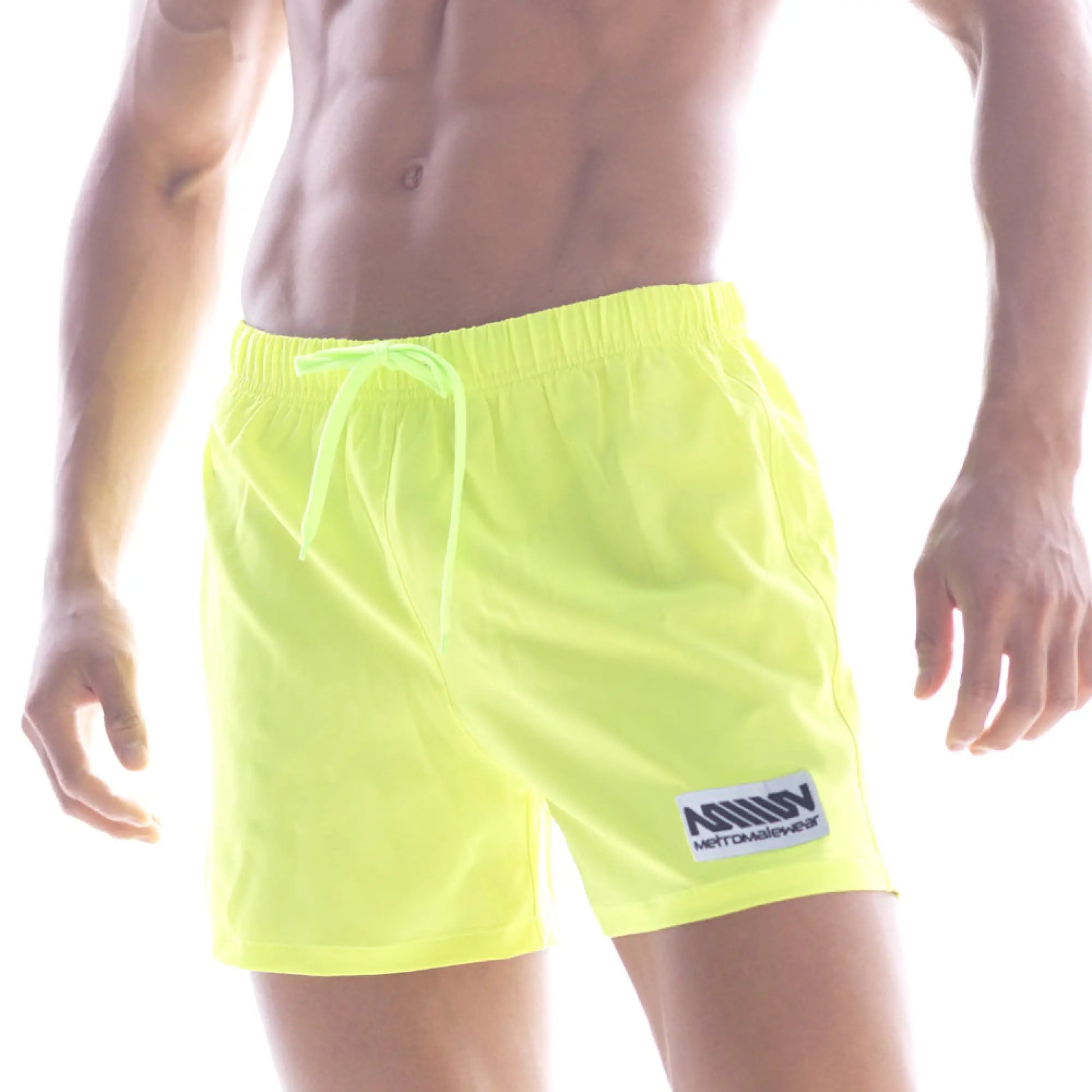 Metro male wear flexible neon yellow swim trunks with matching drawstring and white logo patch on lower left leg