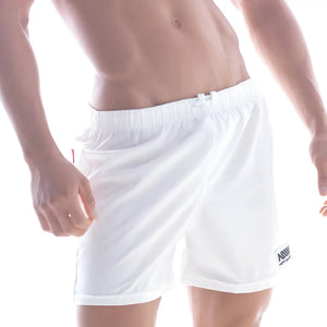 White athletic shorts with elastic waistband and small logo patch on lower right leg by metromalewear