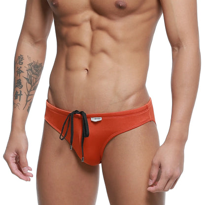 Orange metroMalewear hunter swim brief with black drawstring ties and white brand tag on waistband