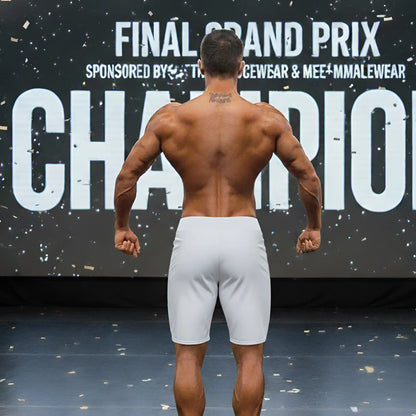 A muscular man shown from the back wearing gray metro musclwear insignia physique board shorts by metromalewear