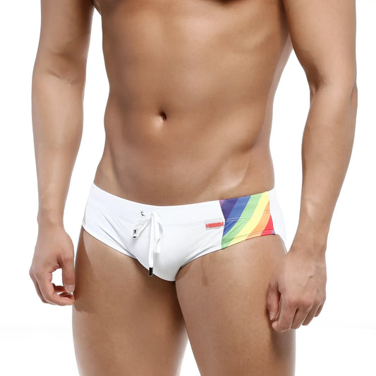 MetroMaleWear rainbow swim brief white featuring vibrant rainbow side stripe and small red brand tag for swimming